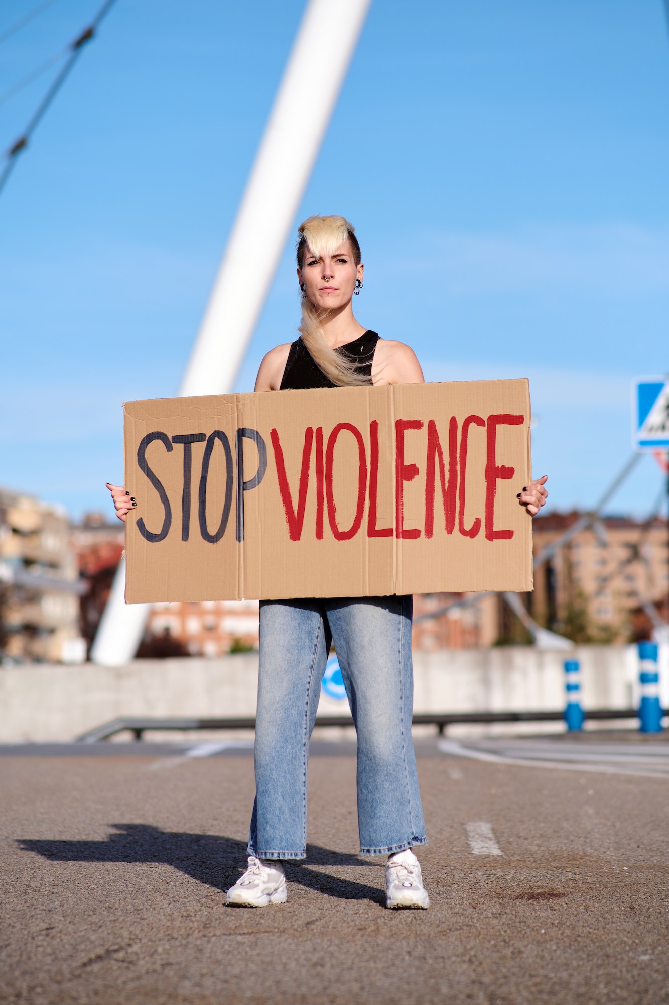 A young protester holding a placard and protesting against gender violence.